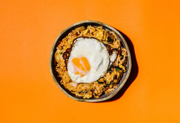 Rice bowl with a fried egg on an orange background