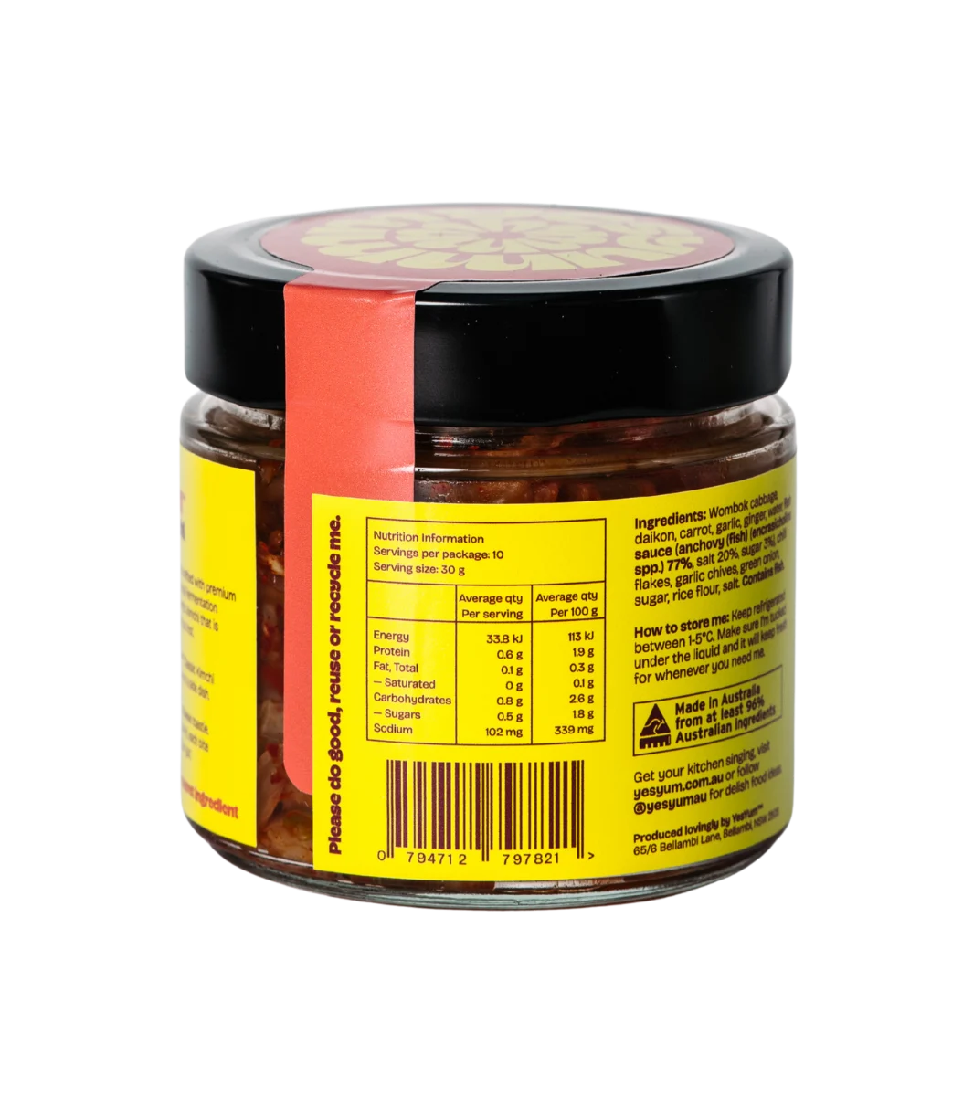 Jar of pickled or preserved food with a yellow label and black lid on a white background