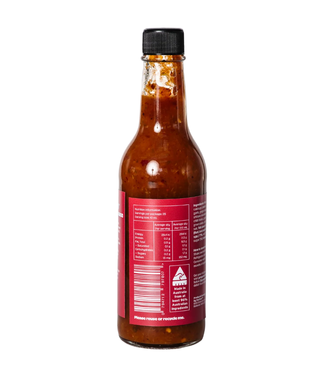 Bottle of hot sauce with a red label on a white background