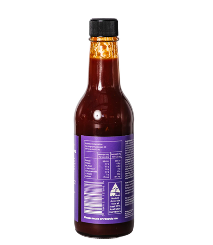 Bottle of hot sauce with a purple label on a white background
