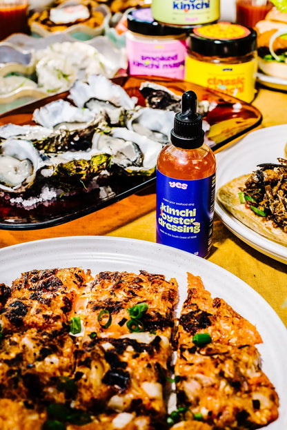 Dessert with kinchil dressing bottle on a table with other food items