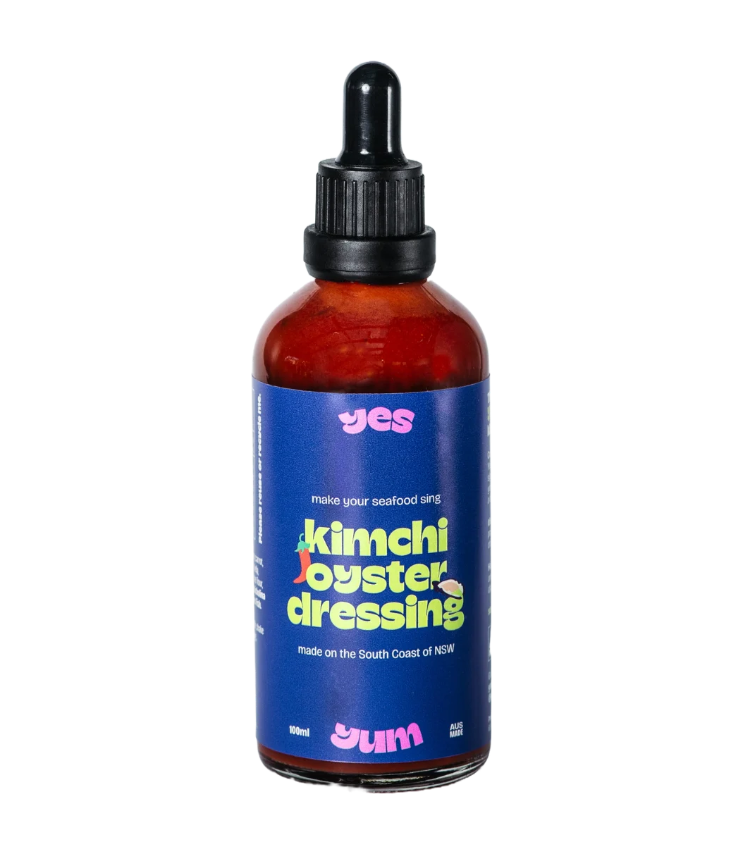 Bottle of kimchi oyster dressing with a blue label on a white background