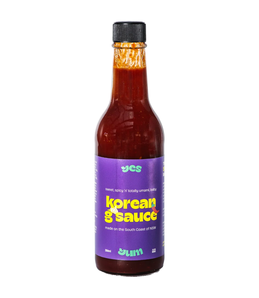 Bottle of Korean G Sauce with a purple label on a white background